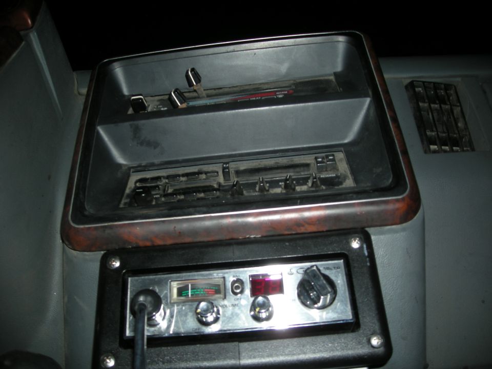 Dashboard area with a CB radio and cassette player slot