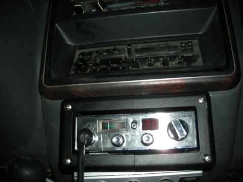 1991 Ford Bronco - Close-up of a vehicle's dashboard showing a CB radio and an older car stereo unit.