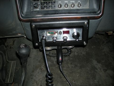 1991 Ford Bronco - Interior view of a vehicle's dashboard showing a CB radio and a 4x4 gear shifter.