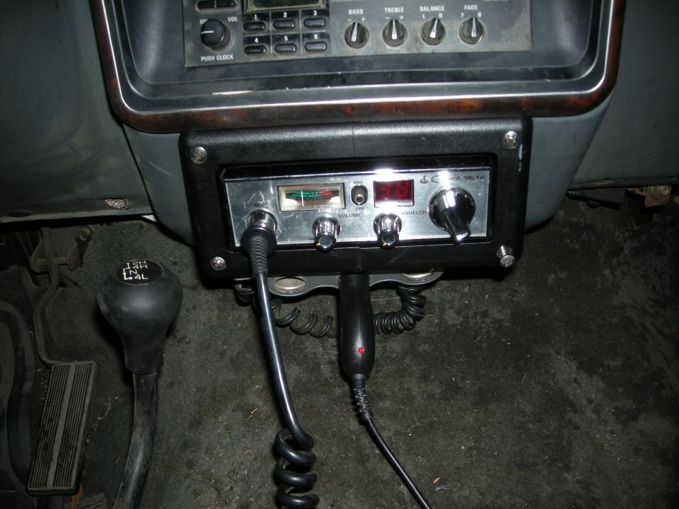 CB radio mounted below dashboard, with gear shifter and floor mat visible