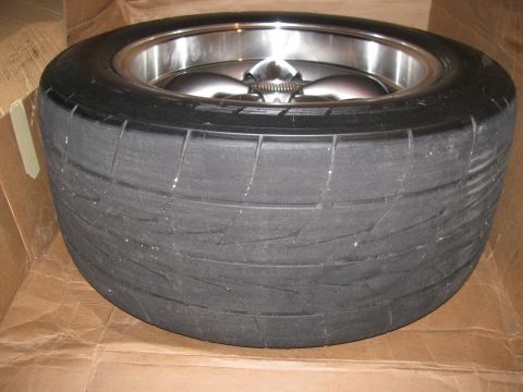 2003 Mercury Marauder - A drag radial tire mounted on a polished chrome wheel sits in a cardboard box.