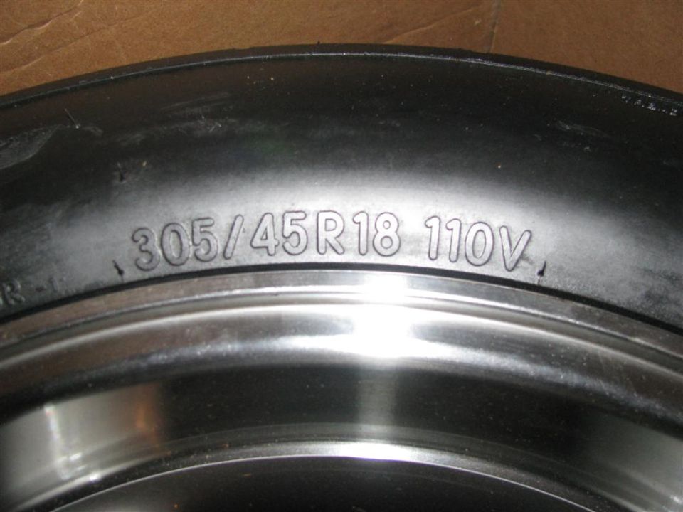 Close-up of tire sidewall showing size 305/45R18 110V