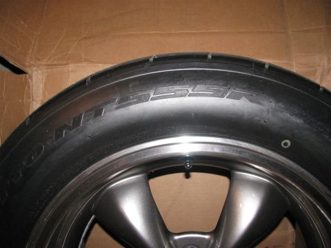 2003 Mercury Marauder - A tire and wheel assembly is shown against a cardboard background.