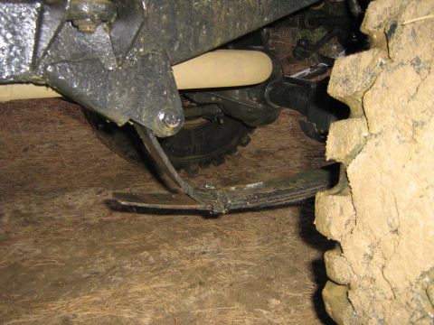 1990 Ford Bronco - The leaf spring appears to be severely damaged and bent.