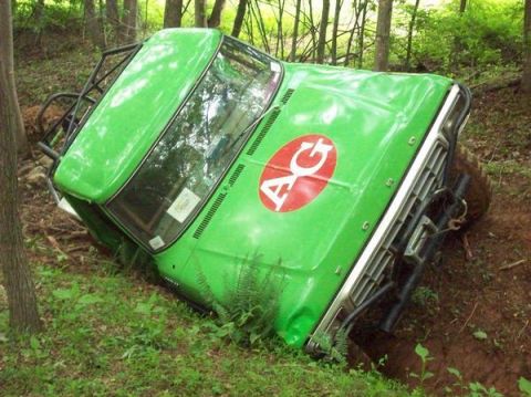 1978 Ford Bronco - This green 1978 Ford Bronco is stuck in a ditch, showing off its off-road capabilities.