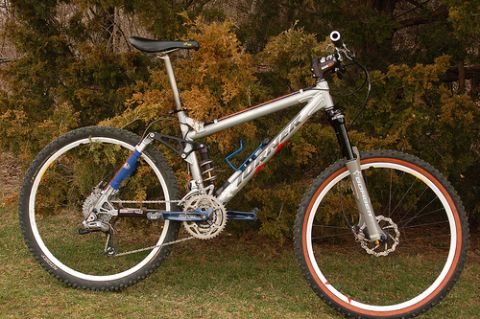 1972 Ford Ranchero - A silver mountain bike with suspension is shown outdoors.