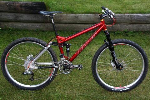 1972 Ford Ranchero - Red Turner mountain bike with silver rear triangle and black suspension fork on grass.