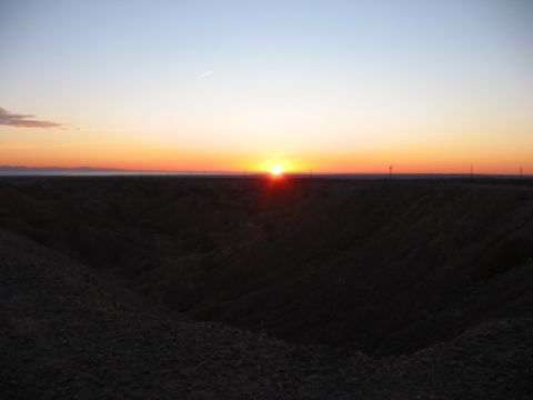 1997 Ford Ranger - A sunset paints the sky with vibrant colors over a desolate, hilly terrain.