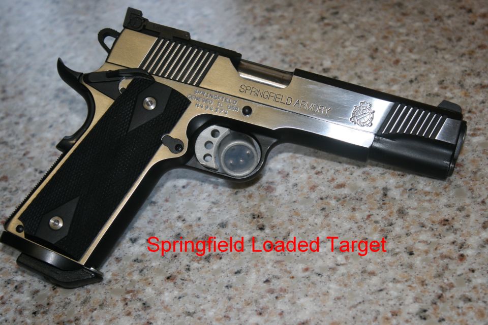 Stainless and black 1911 pistol on granite counter