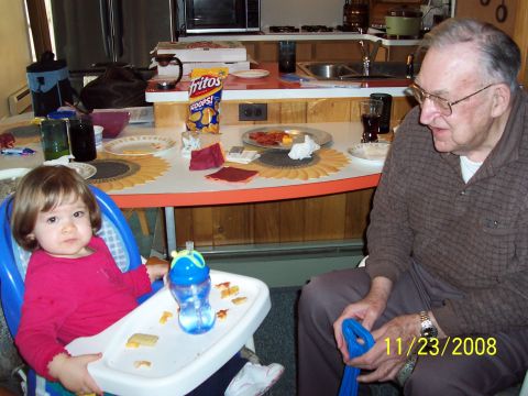 2000 Ford Crown Victoria - A baby in a high chair and an elderly man are seated at a table with food and drinks, with a date stamp of 11/23/2008 visible.