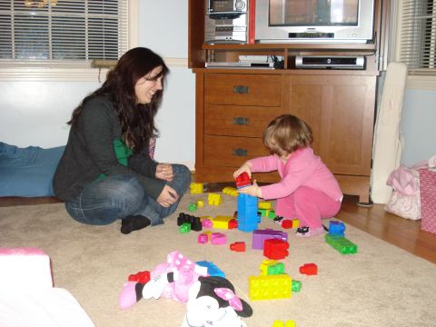 2000 Ford Crown Victoria - A woman and a young child are engaged in play with building blocks in a domestic setting.