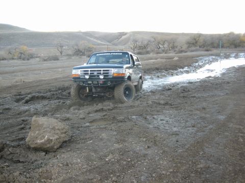 1995 Ford Bronco - This 1995 Ford Bronco navigates a muddy off-road course, its capabilities with a modified bumper and tires.
