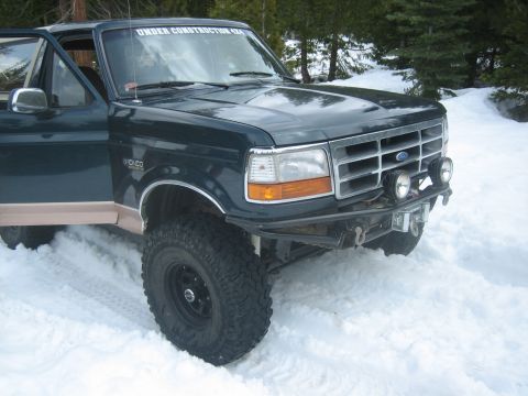 1995 Ford Bronco - This 1995 Ford Bronco features an aftermarket bumper and "UNDER CONSTRUCTION 4X4" sticker, seen here in a snowy environment.