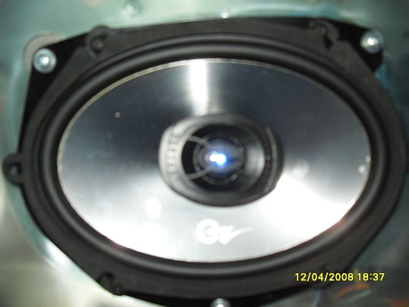 Speaker with silver cone and blue light in center, date stamp 12/04/2008