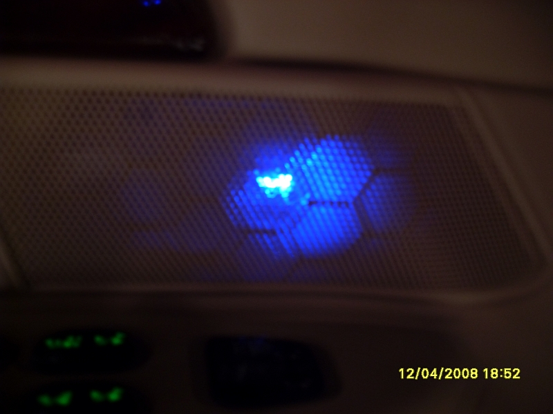 Glowing blue LED in an overhead interior dome light at night