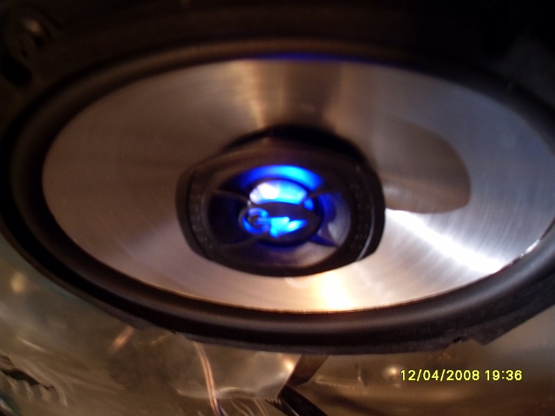 Car speaker with blue illuminated tweeter and brushed metal cone.