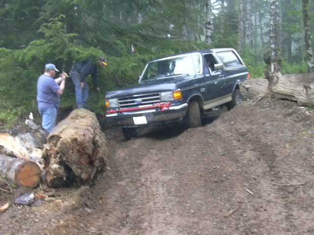 1991 Ford Bronco on a muddy forest trail