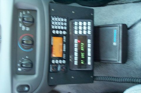 1991 Ford LTD Crown Victoria - Photograph of a police-car console showing radio/scanner equipment and HVAC controls, not a technical document.