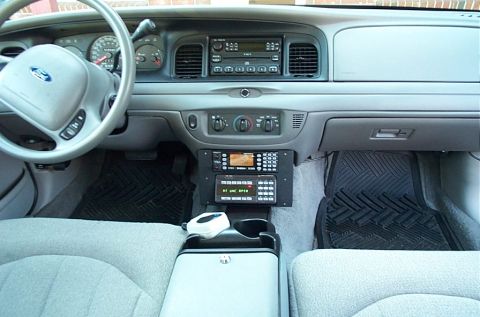 1991 Ford LTD Crown Victoria - Photograph of a Crown Victoria dashboard and steering wheel with radio gear mounted in the console, not a technical document.