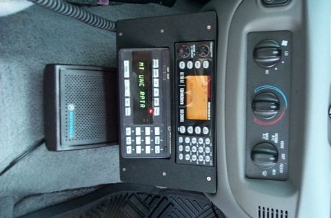 1991 Ford LTD Crown Victoria - Photograph of a police-car console with radio, scanner and climate controls, not a technical document.