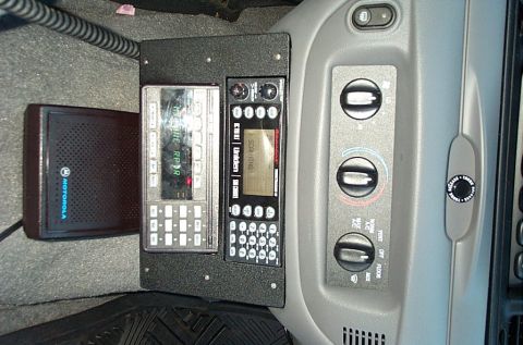 1991 Ford LTD Crown Victoria - Photograph of a police-car console showing a Motorola speaker, radio and HVAC dials, not a technical document.