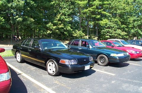 1991 Ford LTD Crown Victoria - Photograph of Ford Crown Victoria police sedans parked in a lot, not a technical document.