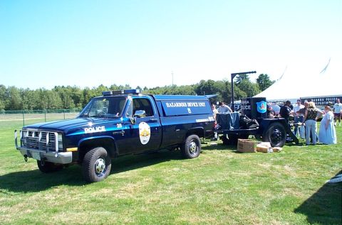 1991 Ford LTD Crown Victoria - Photograph of a police Hazardous Device Unit pickup truck with trailer at an event, not a technical document.