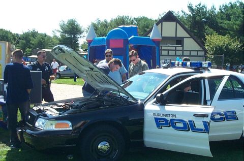1991 Ford LTD Crown Victoria - Photograph of a Burlington Police Crown Victoria with its hood open and onlookers gathered, not a technical document.