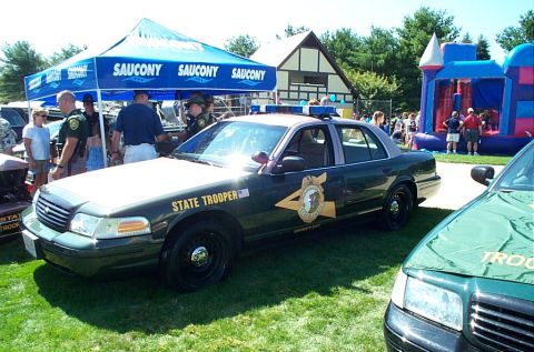 1991 Ford LTD Crown Victoria - Photograph of a State Trooper Ford Crown Victoria police car parked on grass at a public event.