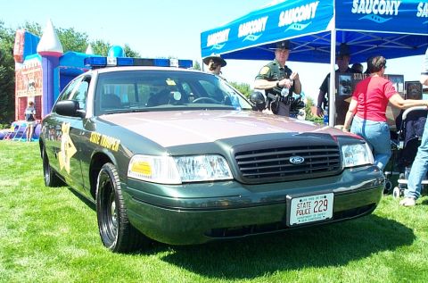 1991 Ford LTD Crown Victoria - Photograph of a State Trooper Ford Crown Victoria displayed under a tent at a public event.