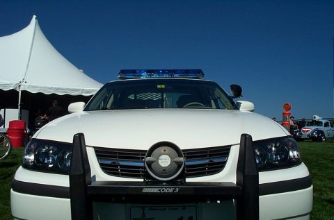 1991 Ford LTD Crown Victoria - Photograph of the front of a white Chevrolet Impala patrol car with a Code 3 light bar.