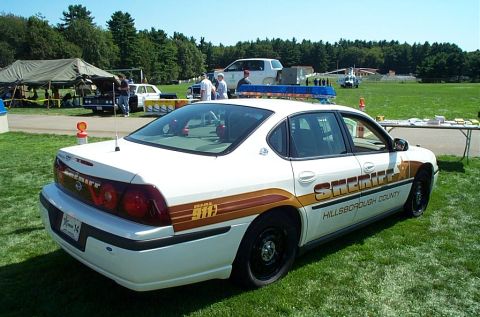1991 Ford LTD Crown Victoria - Photograph of the rear of a Hillsborough County Sheriff Chevrolet Impala patrol car on grass.