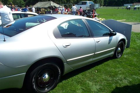 1991 Ford LTD Crown Victoria - Photograph of a silver Chrysler Intrepid sedan parked on grass at a public event.