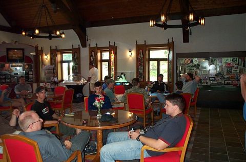 1991 Ford LTD Crown Victoria - Photograph of people gathered indoors at tables in a hospitality lounge.