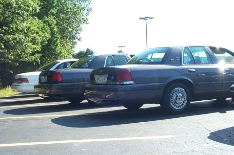 1991 Ford LTD Crown Victoria - Photograph of Ford Crown Victoria sedans parked in a paved lot, not a technical document.