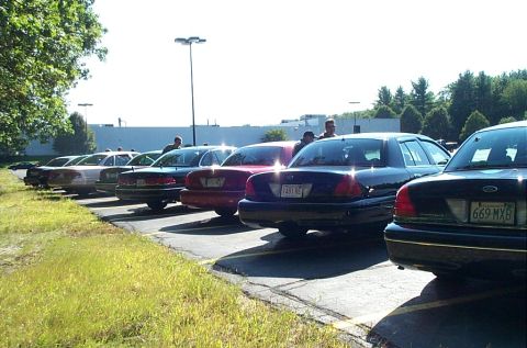 1991 Ford LTD Crown Victoria - Photograph of cars parked diagonally near a building, not a technical document.