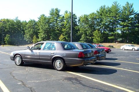 1991 Ford LTD Crown Victoria - Photograph of a gray sedan parked among other cars, not a technical document.