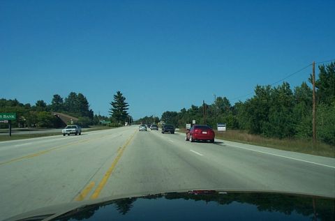 1991 Ford LTD Crown Victoria - Photograph of a divided highway through a windshield, not a technical document.