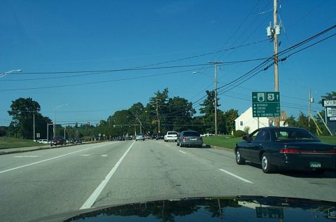 1991 Ford LTD Crown Victoria - Photograph of a roadway with route signs through a windshield, not a technical document.