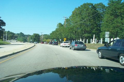 1991 Ford LTD Crown Victoria - Photograph of a multi-lane road with vehicles in traffic, taken from inside a moving car.