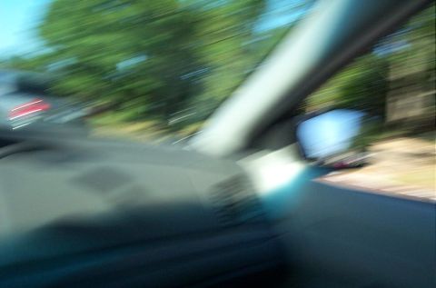 1991 Ford LTD Crown Victoria - Blurred photograph taken from inside a moving car showing the dash and side window.