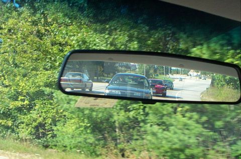 1991 Ford LTD Crown Victoria - Photograph of following traffic seen in a car's rearview mirror.
