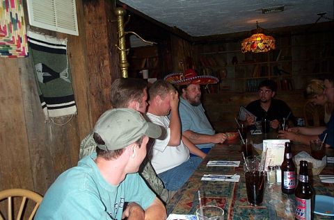 1991 Ford LTD Crown Victoria - A group of friends enjoy drinks and conversation at a table in a restaurant.