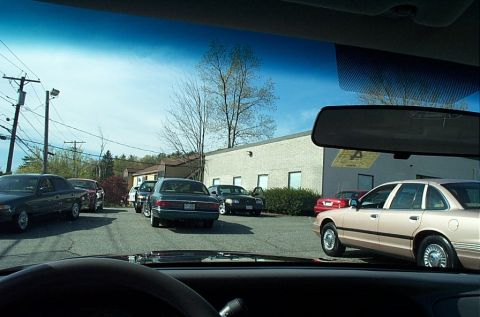 1991 Ford LTD Crown Victoria - Several Ford Crown Victoria-style sedans are parked in a lot, suggesting a fleet or dealership setting.