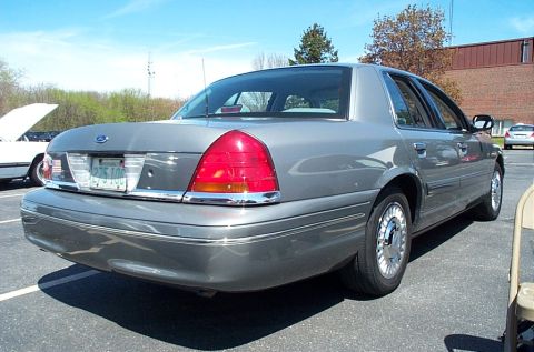 1991 Ford LTD Crown Victoria - Rear view of a gray sedan with chrome accents and a license plate.