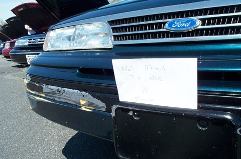 1991 Ford LTD Crown Victoria - A 1991 Ford Crown Victoria LTD is shown with a handwritten sign attached to its bumper, indicating it is not afraid to be used.