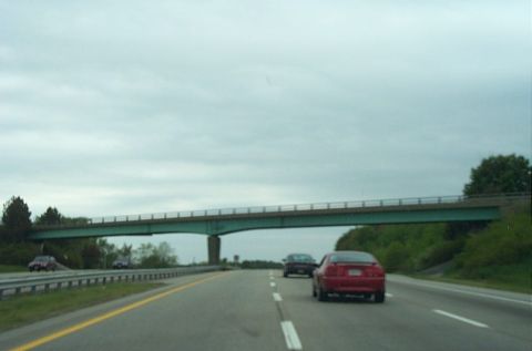 1991 Ford LTD Crown Victoria - Driving on a highway under a green overpass with two cars visible.