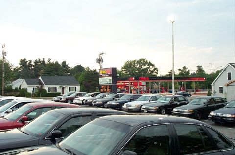1991 Ford LTD Crown Victoria - A row of Ford Crown Victorias, including a 1991 LTD model, are parked outside a Texaco gas station.