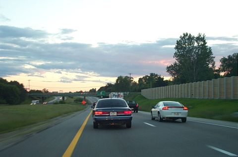 1991 Ford LTD Crown Victoria - Rear view of a 1991 Ford Crown Victoria LTD on a highway during twilight.