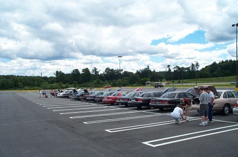 1991 Ford LTD Crown Victoria - Several 1991 Ford Crown Victoria LTDs are parked in a lot on a cloudy day.